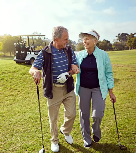 older couple standing around looking like they're about to ruin a good walk
